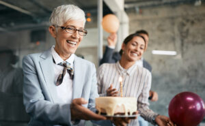 Image of woman carrying birthday cake