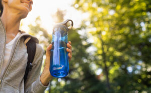 Image of person holding a water bottle