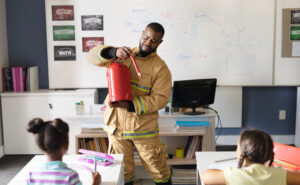 Photo of fireman teaching a classroom of young students as a guest speaker
