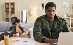 Photo of military member working on a computer