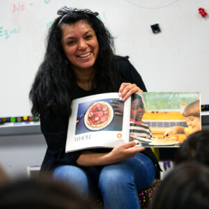 Teacher reading a book to her classroom