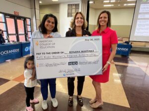 ACE leaders presenting large check for a full ride Master's Degree scholarship to Rosana Martinez