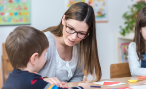 image of teacher helping a student