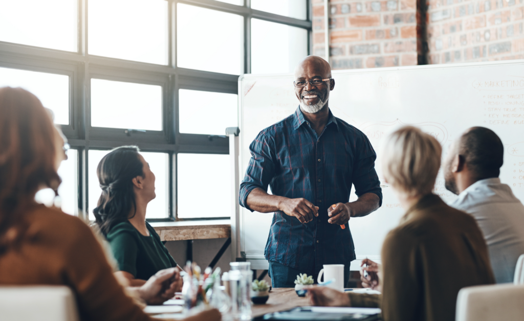 image of leader speaking to a team at work