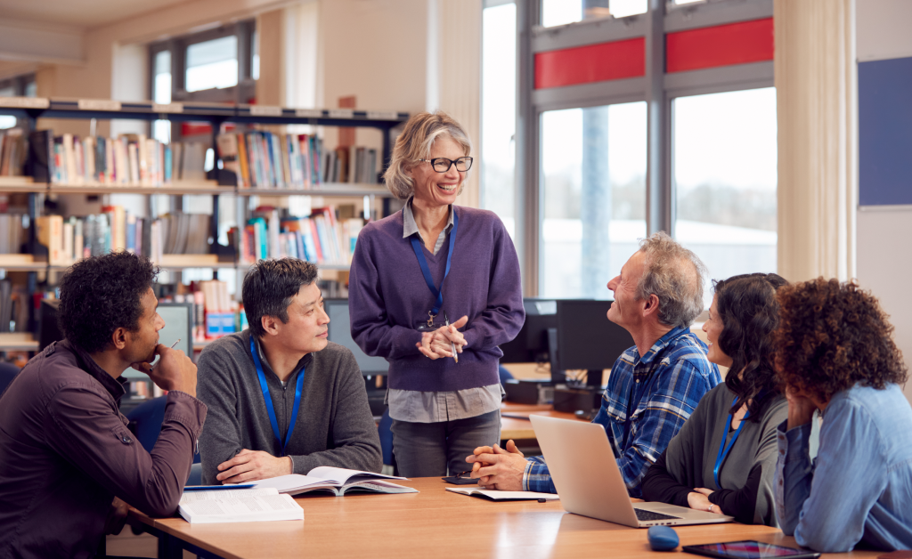 Teachers conferring with each other in a library