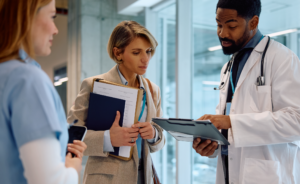 A Healthcare Consultant talking with a nurse and a doctor