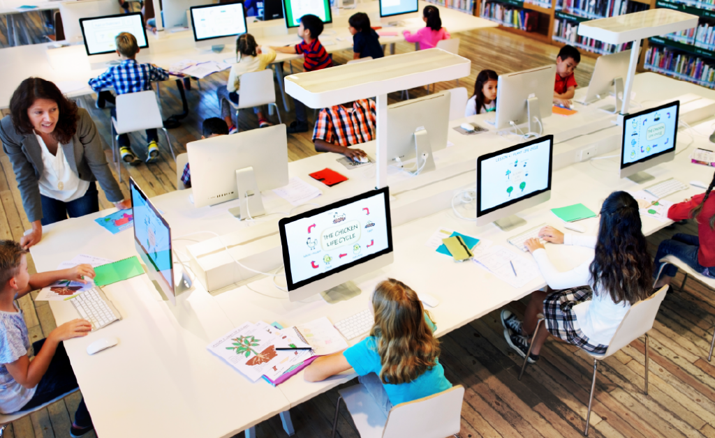 Children using desktop computers in a classroom or library computer lab