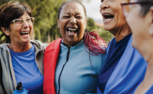 A group of women laughing together outdoors