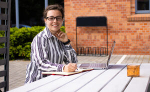 Female teacher working outside at a table in the summer