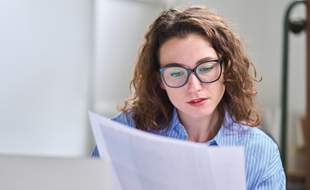 Woman with glasses reading a document